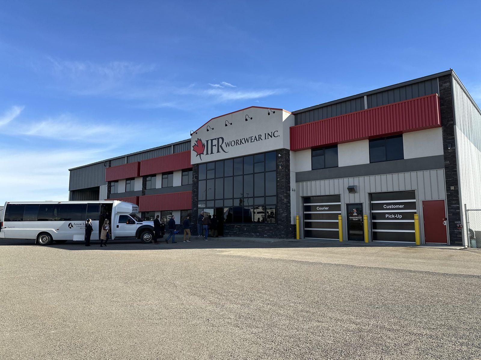 IFR Workwear facility exterior with investor charter bus